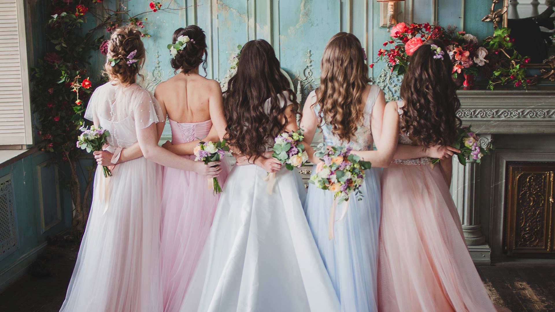 bride and bridesmaids in gowns and dresses